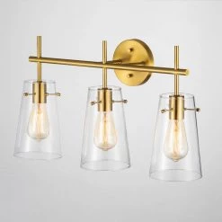 24 in. 3-Light Antique Brass Vanity Light with Clear Glass Shade by Kawoti 10 24 in. 3-Light Antique Brass Vanity Light with Clear Glass Shade by Kawoti -Safavieh Sales antique brass kawoti vanity lighting 21066 1f 1000