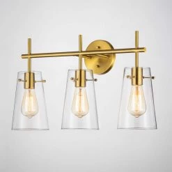 24 in. 3-Light Antique Brass Vanity Light with Clear Glass Shade by Kawoti 9 24 in. 3-Light Antique Brass Vanity Light with Clear Glass Shade by Kawoti -Safavieh Sales antique brass kawoti vanity lighting 21066 4f 1000